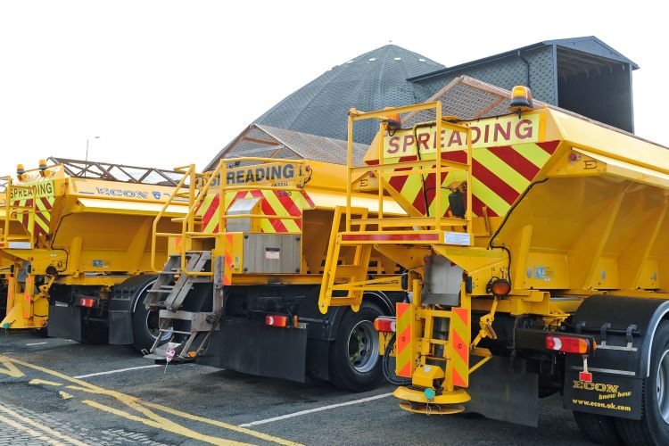 Yellow gritting vehicles for spreading salt on the roads