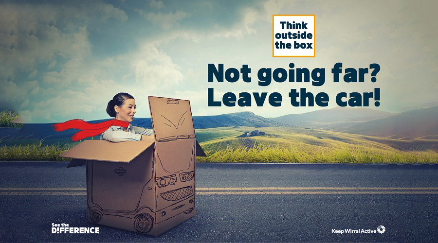 Think outside the box. Not going far? Leave the car! Image shows a person travelling along a road in a cardboard box