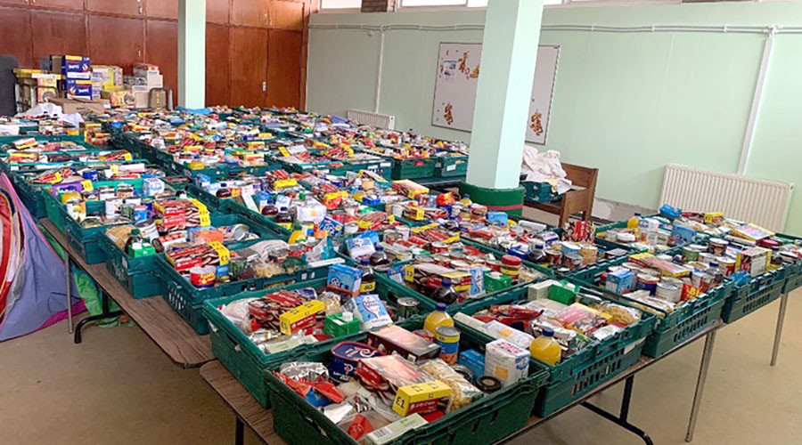 Boxes of food supplies laid out on tables