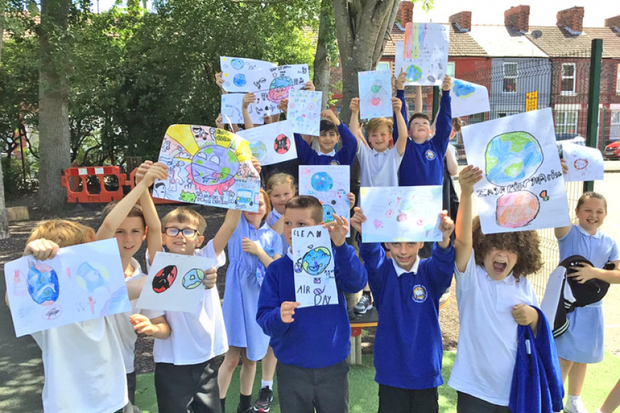Year 4 pupils hold up their Clean Air Day posters