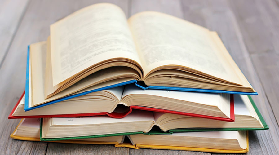 A stock image showing a pile of opened books