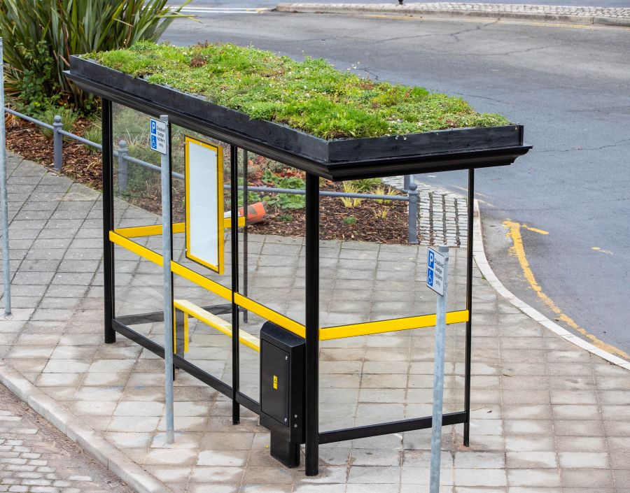 Birds eye view of the bus shelter so that you can see the lush green grass on the roof of the shelter