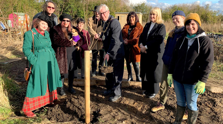 Photo of the Mayor and a group of volunteers planting a tree on Holocaust Memorial Day.