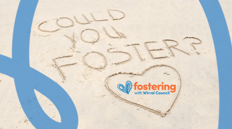 Close-up of beach with Could you foster? written in the sand with a heart below text with Fostering in Wirral logo
