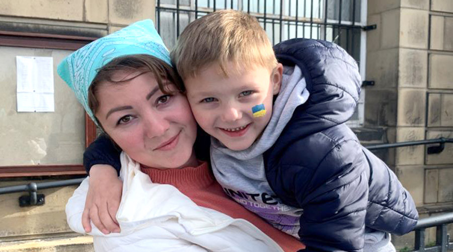Ukraine mother and son embracing in front of Wallasey Town Hall