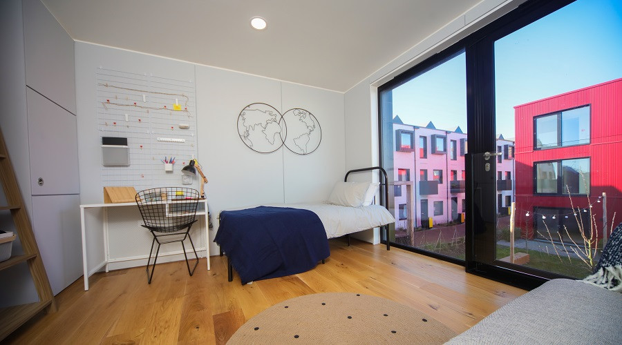 image from inside one of the redbridge quay homes showing a sitting room and another modular home through the window