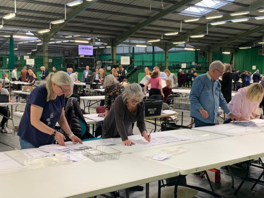 workers counting votes at Bidston tennis centre following May 2023 local elections in Wirral