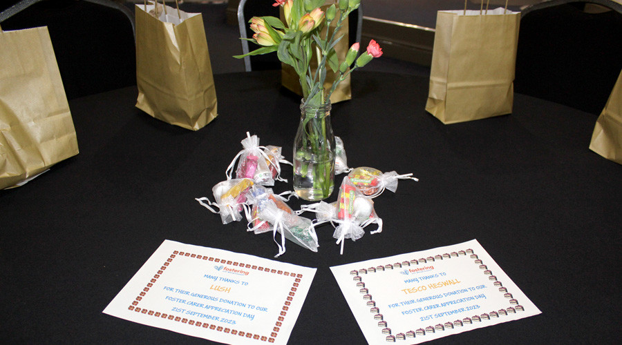 Fostering appreciation day gift bags on table with flower centre piece