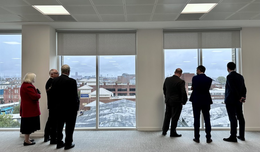 People looking out of the new office building in Birkenhead towards Birkenhead Market