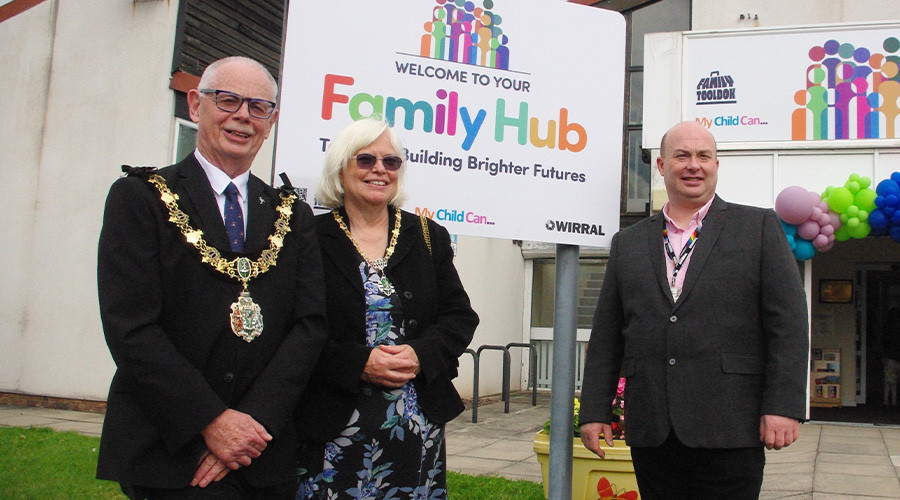 Mayor and Mayoress of Wirral, the Leader of Wirral Council, in front of the Family Hub sign in Seacombe