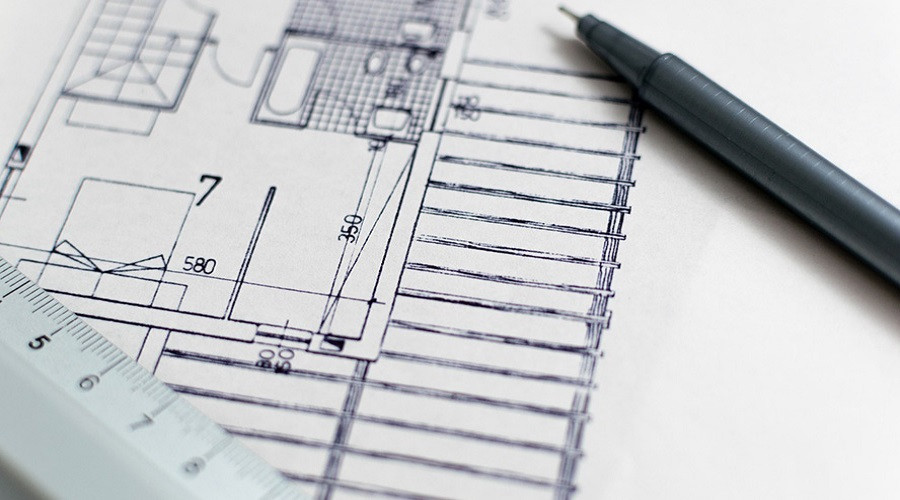 image of an architectural plan and a pen