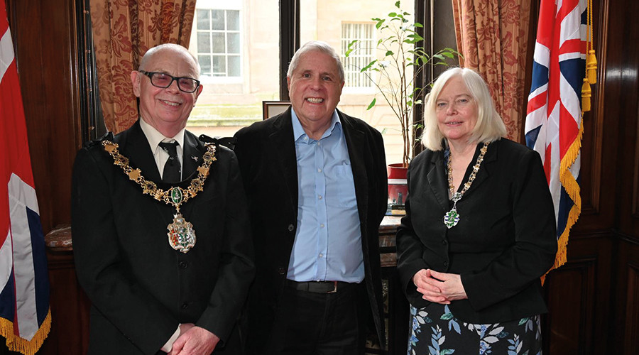 Photo of the Mayor and Mayoress congratulating Norman, Wirral Council's longest-serving member of staff.