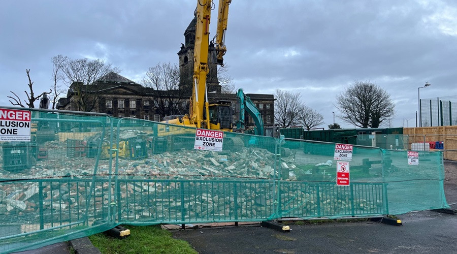 image showing demolition of Wallasey town hall south annexe largely demolished, digger in foreground and town hall now visible behind it