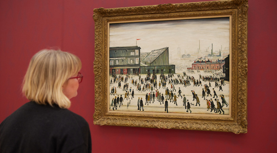 Photo of a person admiring the painting on a gallery wall