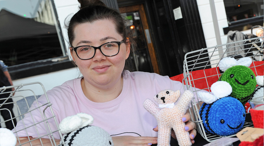 One of the young traders holding out her products