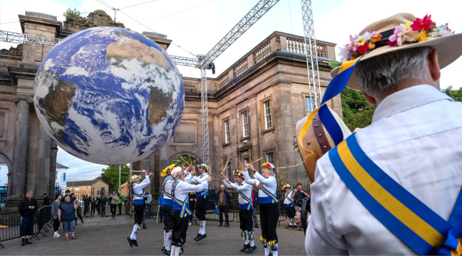 Morris dancers performing in front of Gaia.