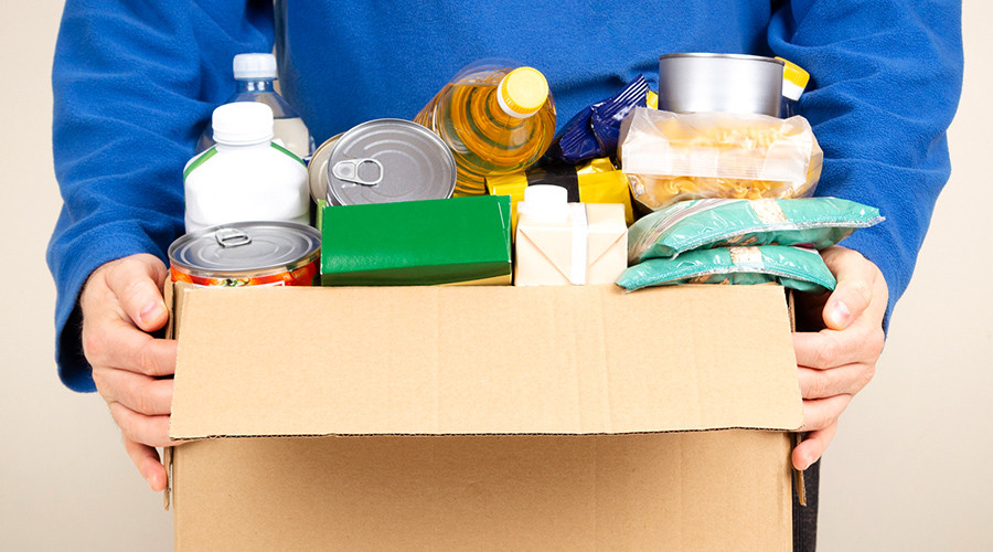 Picture of pair of hands holding a box of essential store cupboard items