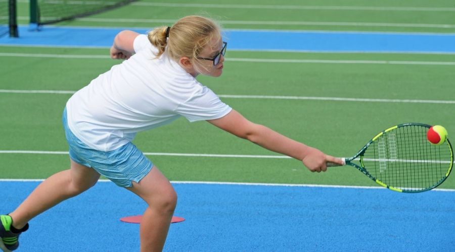 Child playing tennis on new revamped course.