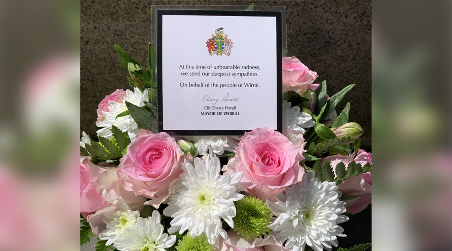 A photo of flowers with a card that reads ' At this time of unbearable sadness, we send our deepest sympathies. On behalf of the people of Wirral. Cherry Povall, Mayor of Wirral.