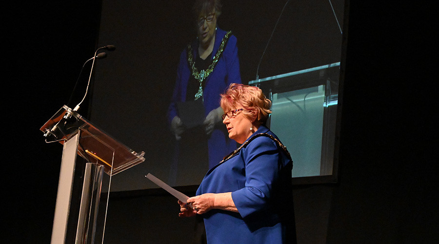 The Mayor of Wirral standing at a podium in the theatre