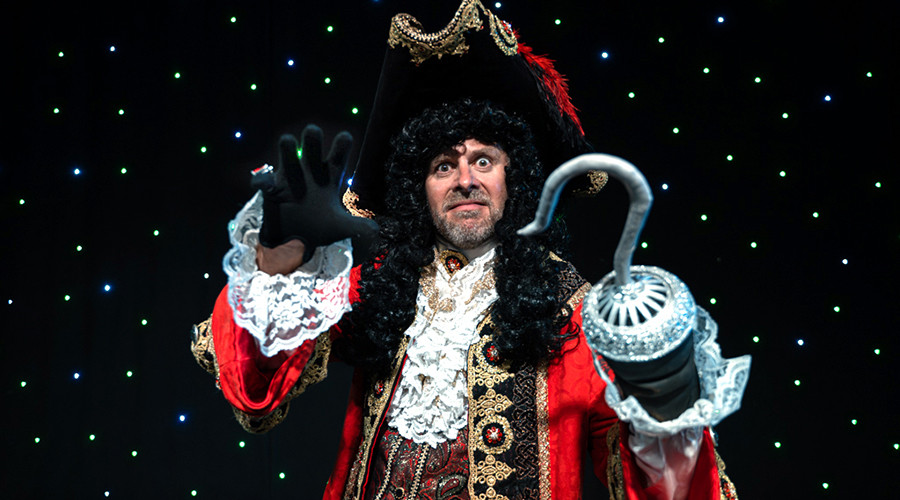 PPhoto of Tom Lister in a Captain Hook costume in front of a star cloth