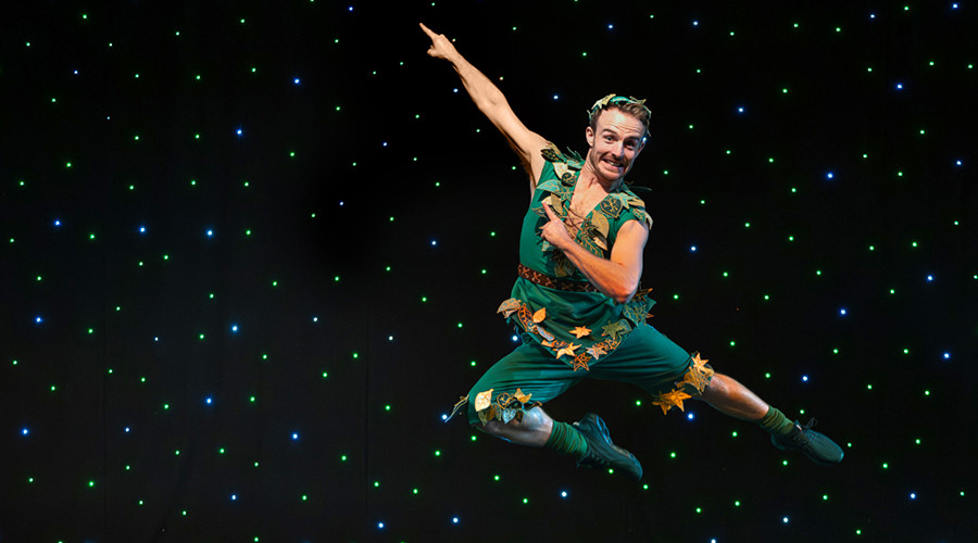 Photo of Danny Colligan dressed as Peter Pan while soaring through the air