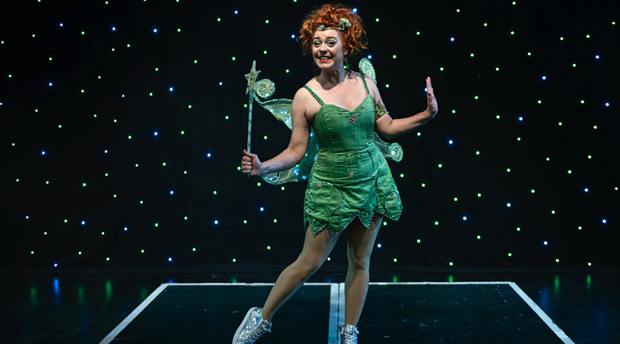 Photo of Holly Atterton in a Tinker Bell costume in front of a star cloth