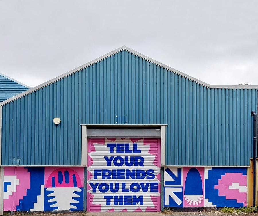 Bright artwork on an industrial building by Art Jam artist Andrew Wolfenden