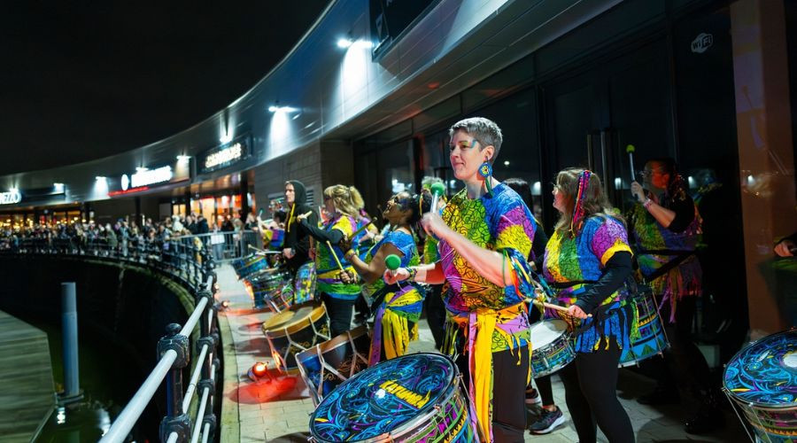 Photo of brightly dressed drummers performing