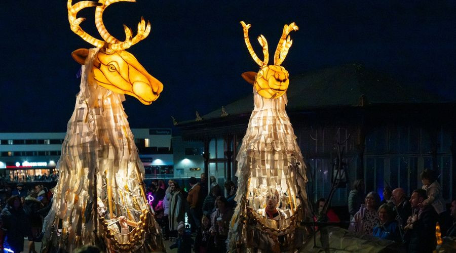 Photo of two giant illuminated Caribou on the Promenade