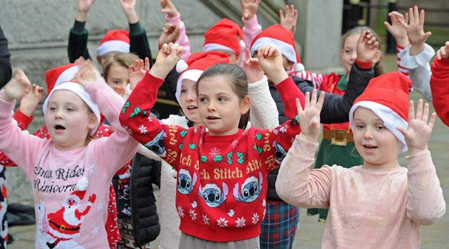 Children from St Peter's Primary singing Christmas songs