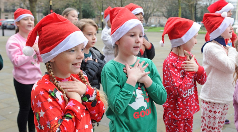 Children from St Peter's Primary singing Christmas songs