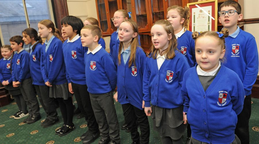 Photo of the Choir of Mersey Park Primary singing to guests.