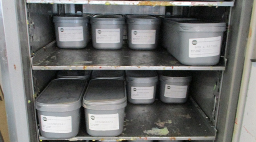 Dirty shelving units inside freezer