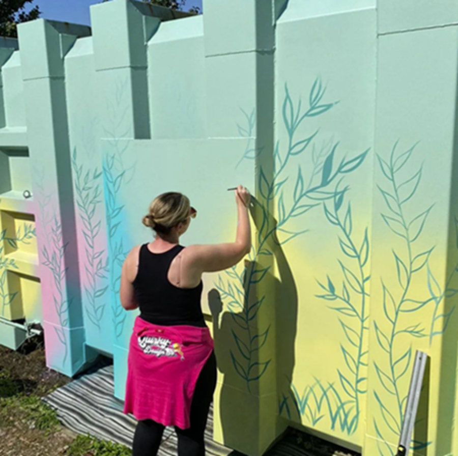 Rachel Smith Evans paints a bright mural outside