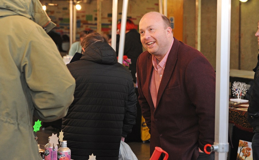 Wirral Council Leader, Cllr Paul Stuart, talking to a young trader at Wirral Youth Market