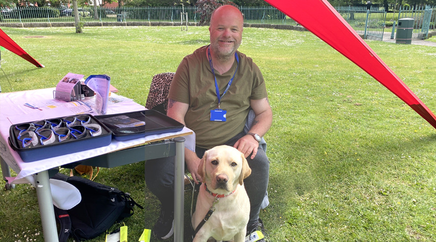 John sitting and his guide dog Dodger
