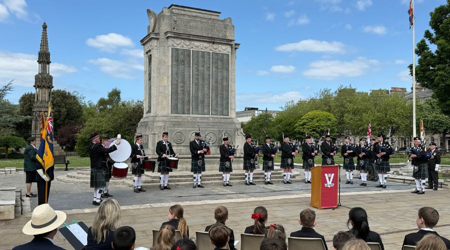 Photo of pipers and drummers playing at the Cenotaph