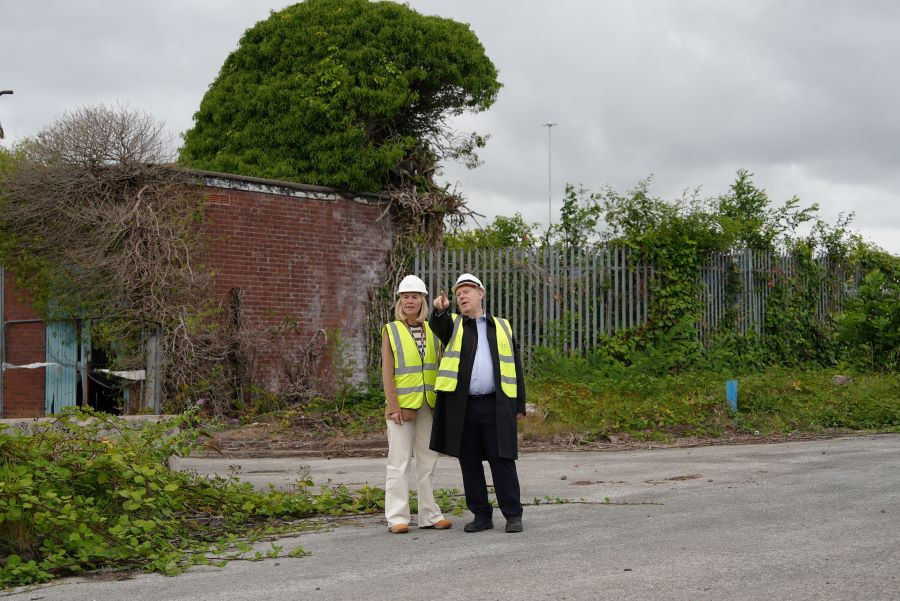 Cllr Basnett and Steve Parry shown on site at Hind Street with vegetation and old buildings in the background
