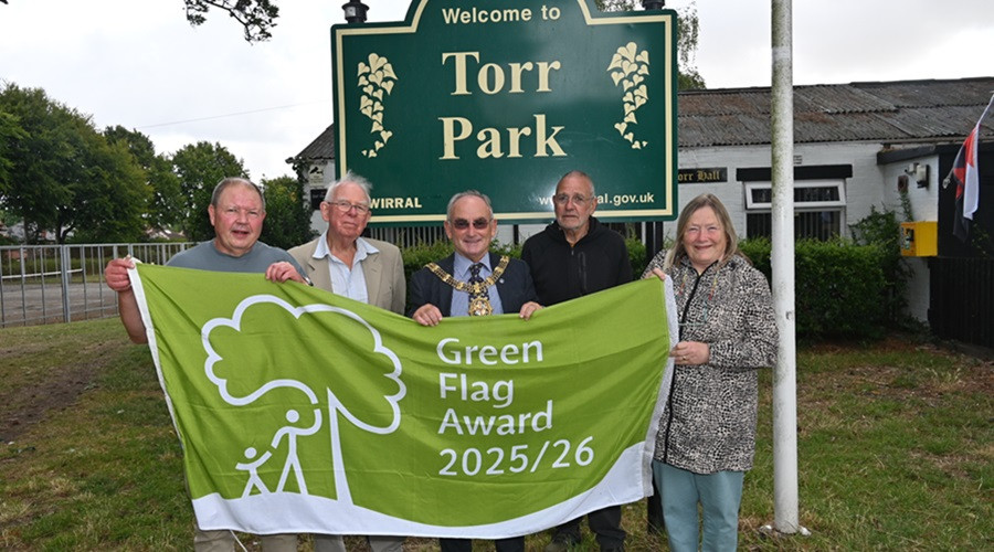 Group of people at Torr Park with Wirral's Mayor Brian Kenny holding a Green Flag