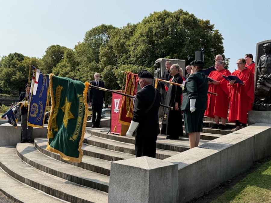 Photo of Flag Standards being lowered during the National Anthem
