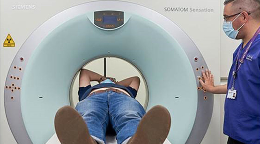 Senior man laying down being scanned