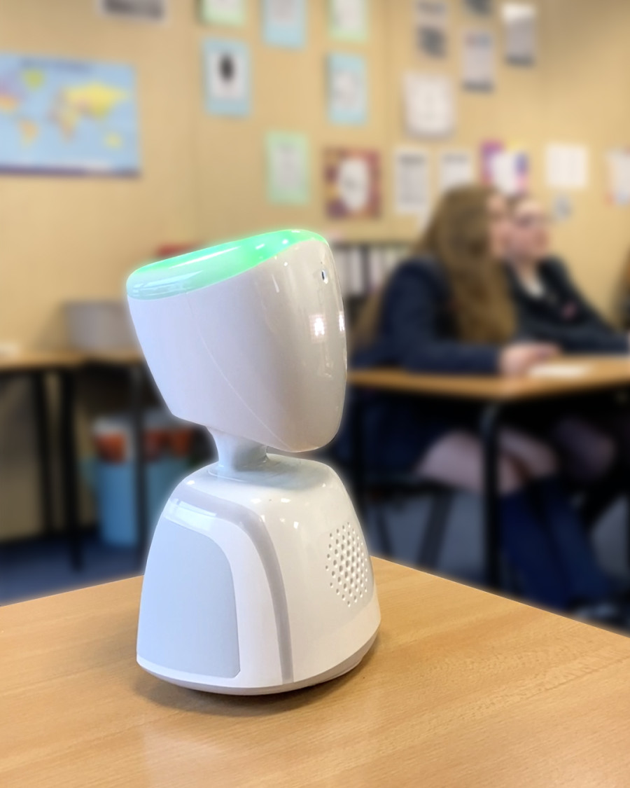 AV1 robot sits on a classroom desk