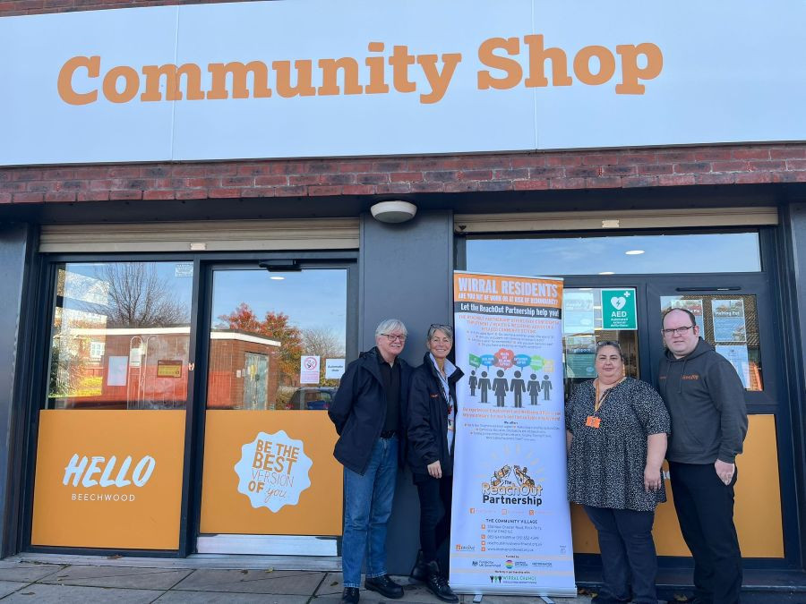 David and ReachOut staff are pictured standing in front of a pop up banner outside the Beechwood Community Shop