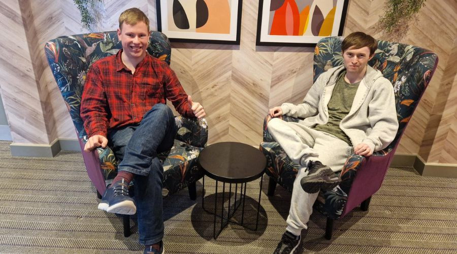 Michael and Jamie sitting in armchairs