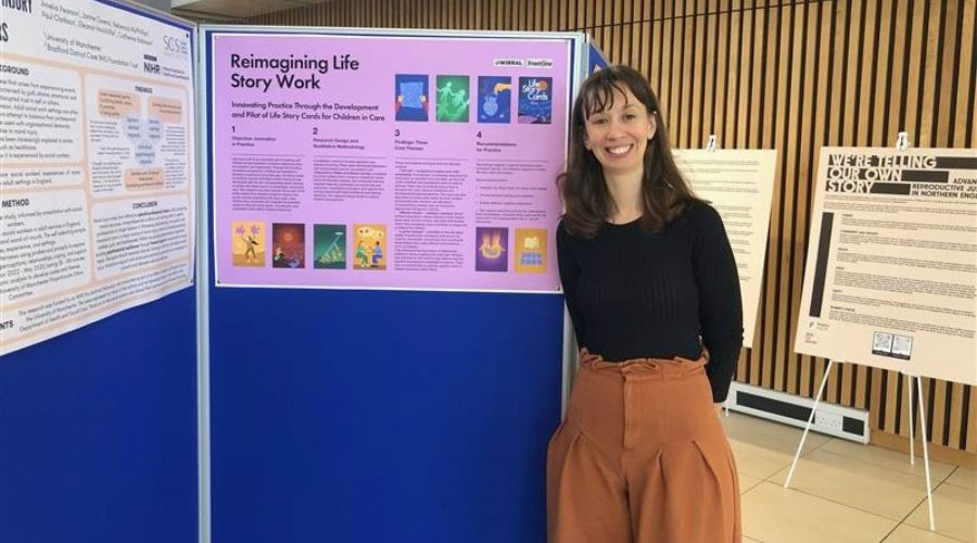 Woman standing beside display that shows a project around Life Story cards