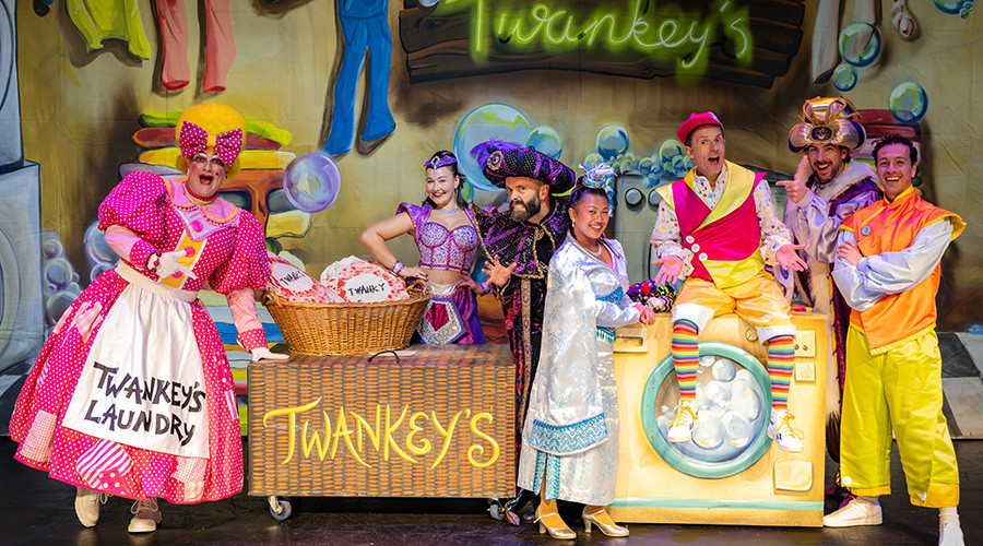 The cast of Aladdin grouped together on stage at the Floral Pavilion