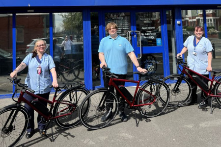 Carers standing by government-funded e-bikes