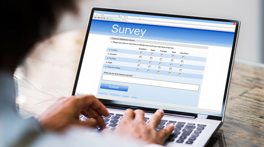 A person completing an online survey on a laptop
