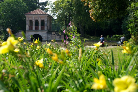 Birkenhead Park in spring, with daffodils in the foreground and the Swiss Bridge in the background